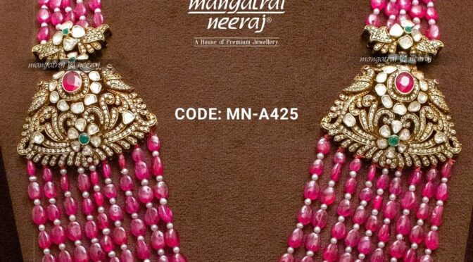 Muti layered ruby beads with side pendants.